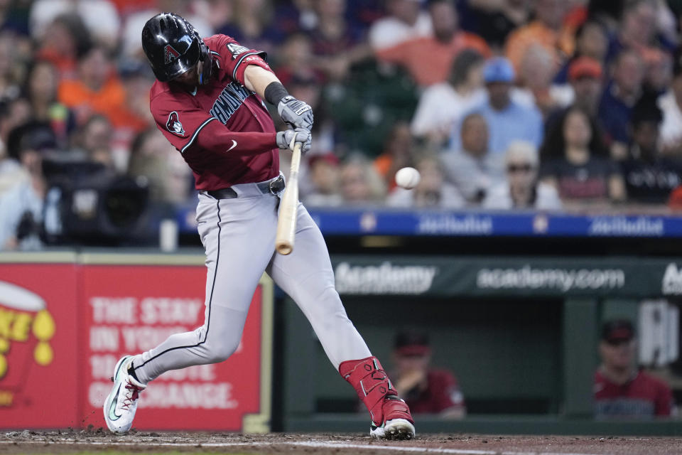 Arizona Diamondbacks' Kevin Newman hits an RBI single against the Houston Astros during the second inning of a baseball game, Saturday, Sept. 7, 2024, in Houston. (AP Photo/Eric Christian Smith)