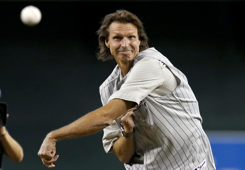 Former Arizona Diamondbacks pitcher Randy Johnson throws out the first pitch during ceremonies commemorating the 10th anniversary of Johnson's perfect game prior to a baseball game between the Diamondbacks and the Los Angeles Dodgers on Sunday, May 18, 2014, in Phoenix. (AP Photo/Ross D. Franklin)