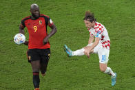 Croatia's Luka Modric, right, clears the ball against Belgium's Romelu Lukaku during the World Cup group F soccer match between Croatia and Belgium at the Ahmad Bin Ali Stadium in Al Rayyan, Qatar, Thursday, Dec. 1, 2022. (AP Photo/Ebrahim Noroozi)