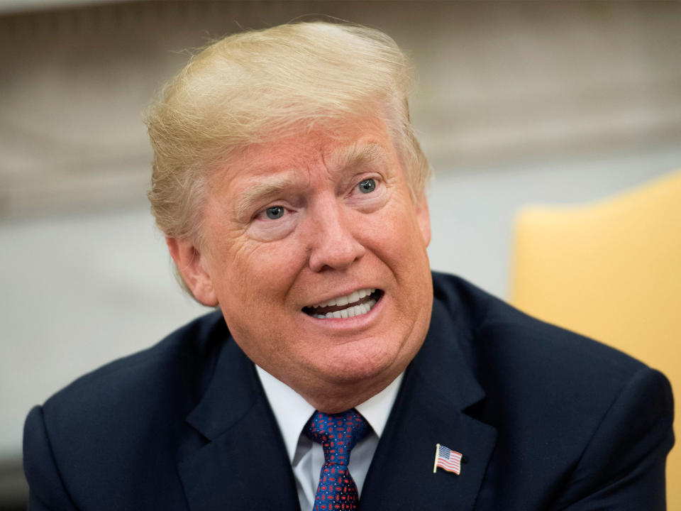 Donald Trump speaks to the media during a meeting with Governor Ricardo Rossello of Puerto Rico in the Oval Office at the White House on 19 October: Getty