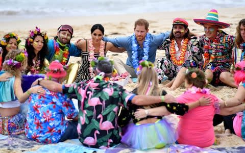 Prince Harry and Meghan, Duchess of Sussex meet a local surfing community group, known as OneWave, raising awareness for mental health and wellbeing on Bondi Beach  - Credit: Dominic Lipinski /PA