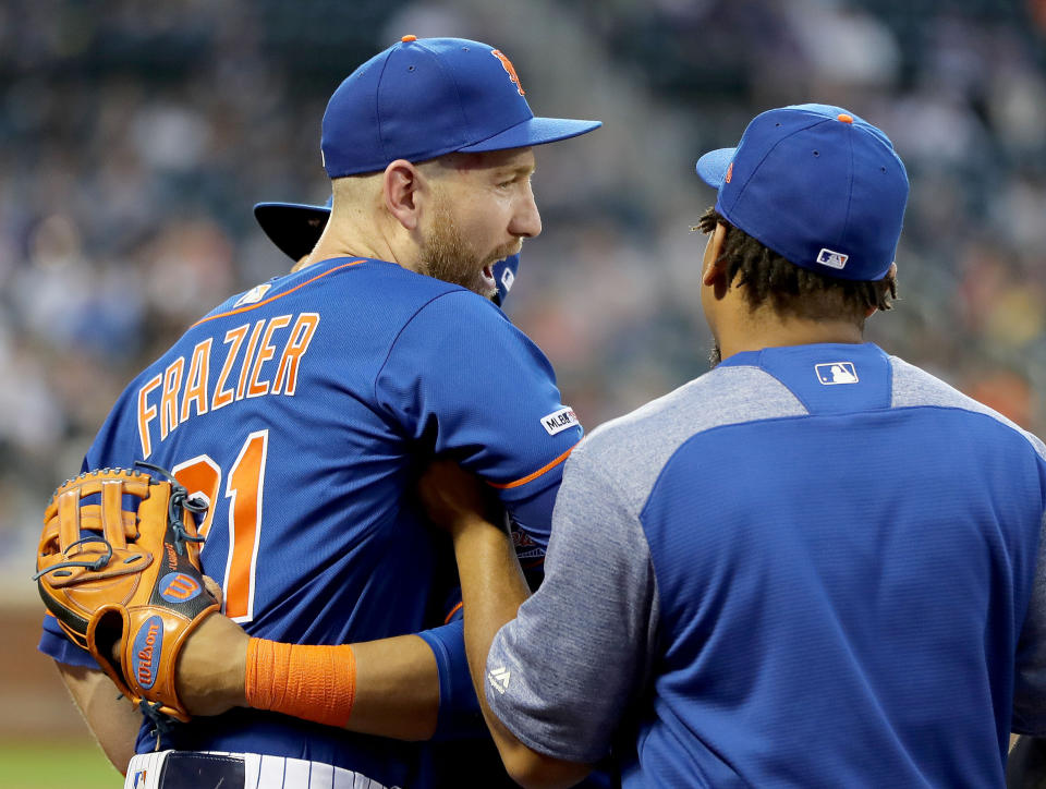 NEW YORK, NEW YORK - MAY 20:  Todd Frazier #21 of the New York Mets is held back by teammates Juan Lagares #12 and Dominic Smith #22 as he and Adam Eaton #2 of the Washington Nationals have a heated discussion in the third inning at Citi Field on May 20, 2019 in the Flushing neighborhood of the Queens borough of New York City. (Photo by Elsa/Getty Images)