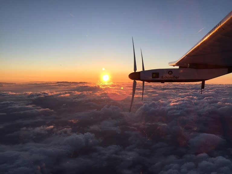 This handout photo taken early on June 29, 2015 and provided by the Solar Impulse project shows sunrise a little while after the Swiss-made solar-powered plane Solar Impulse 2 took off from the international airport in Nagoya, Japan