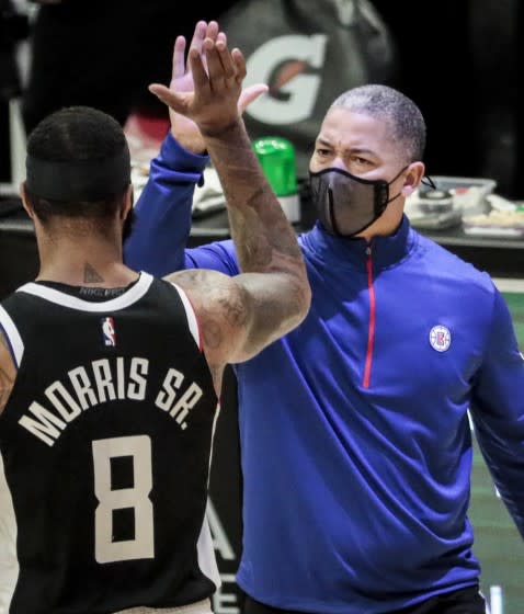 Clippers head coach Tyronn Lue high-fives forward Marcus Morris during a break in the action against the Pacers.
