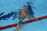 Caeleb Dressel, of the United States, after swimming to victory in a men's 100m butterfly semifinal at the 2020 Summer Olympics, Friday, July 30, 2021, in Tokyo, Japan. (AP Photo/Jeff Roberson)