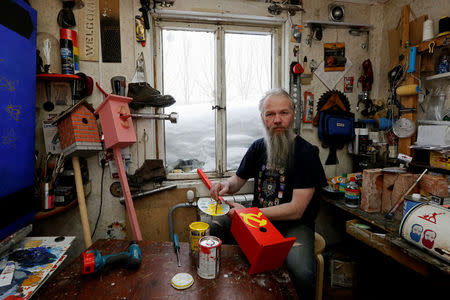 Vasily Slonov, 48, artist and supporter of presidential candidate Pavel Grudinin, poses for a picture inside his workshop in Krasnoyarsk, Russia, February 8, 2018. "I don't think that this will be Putin's final term in office. In fact I see a sort of messianic energy in Putin," said Slonov. "He’s not just any other person, but something of an instrument in God's hands. He's not simply a politician." REUTERS/Ilya Naymushin