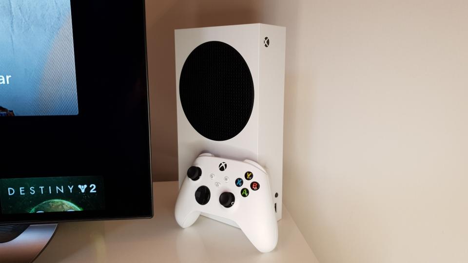 Xbox Series S standing vertically next to a TV
