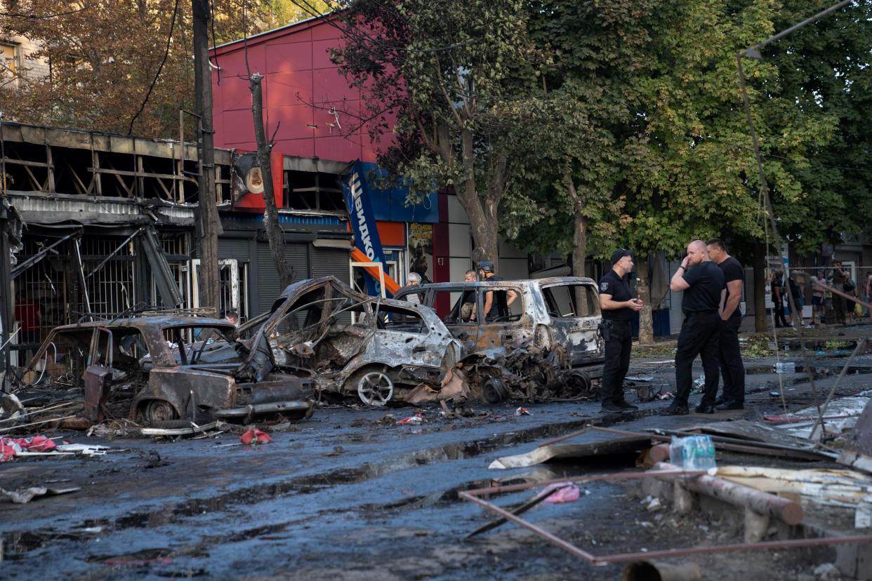 Burnt cars are seen at the site at of a Russian strike at a market in Kostyantynivka (AFP via Getty Images)