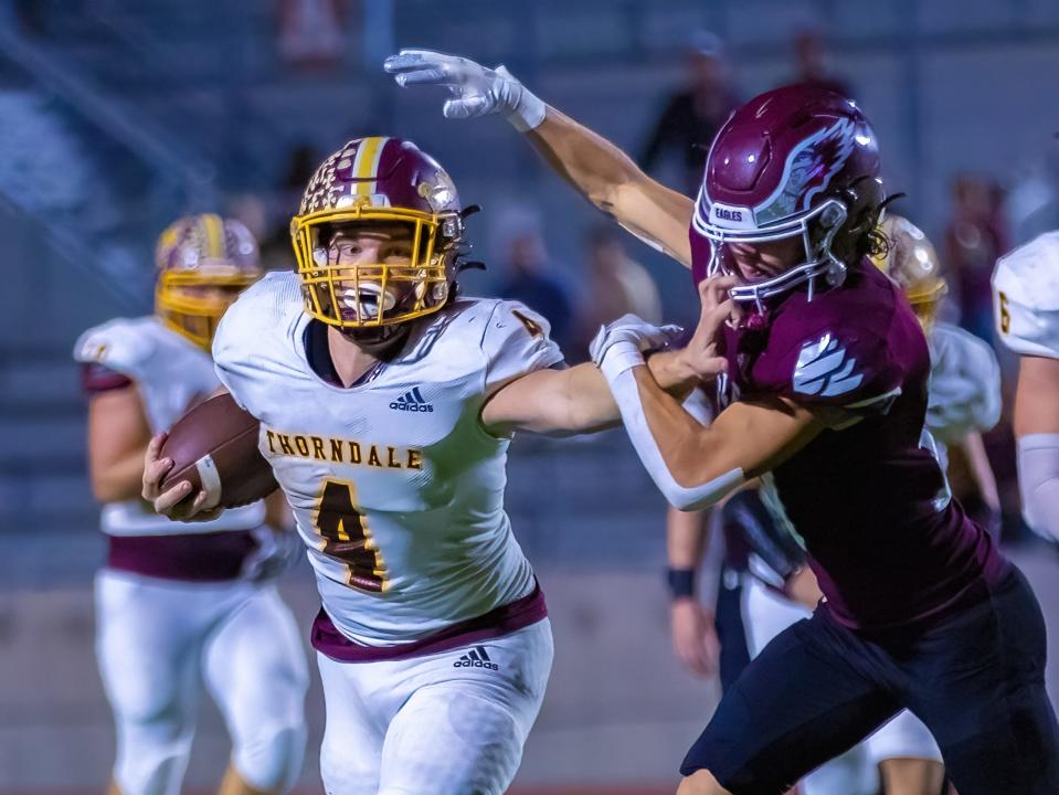 Thorndale quarterback Coy Stutts stiff-arms Johnson City defensive back Josh McKennis for extra yards during the teams' playoff opener Thursday.  Stutts accounted for 344 total yards and five touchdowns in the 41-30 win.