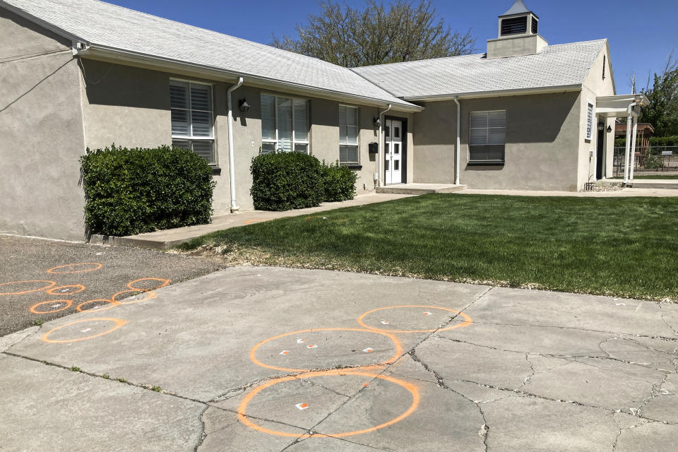 Image: Painted circles mark locations where evidence related to a deadly shooting was collected in front of a church in Farmington, N.M., on May 16, 2023.  (Susan Montoya Bryan / AP)