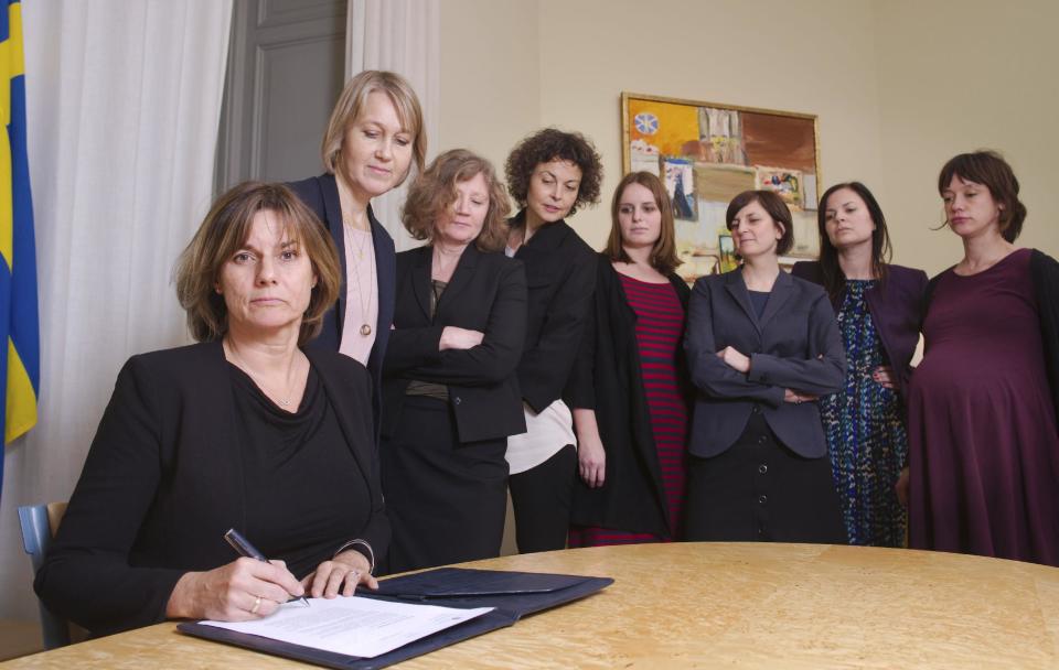 In this handout photo provided by the Swedish Government, Sweden's Deputy Prime Minister Isabella Lovin, left, signs a proposal for the Scandinavian country's new climate law in Stockholm, Friday, Feb. 3, 2017. Sweden's Deputy Prime Minister has posted on Facebook an all-woman photo including herself signing a proposal for the Scandinavian country's new climate law - a photo many online commentators have taken as a direct swipe at Donald Trump. (Johan Schiff/Swedish Government via AP)