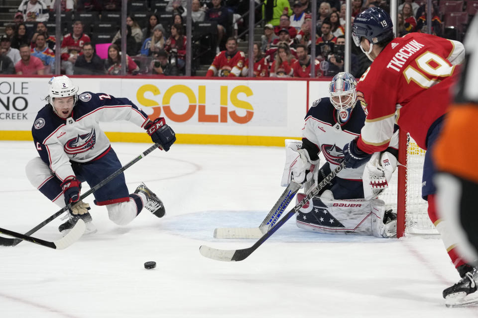 Florida Panthers left wing Matthew Tkachuk (19) attempts a shot on the goal as Columbus Blue Jackets defenseman Andrew Peeke, left and goaltender Elvis Merzlikins, right, defends during the second period of an NHL hockey game, Tuesday, Dec. 13, 2022, in Sunrise, Fla. (AP Photo/Lynne Sladky)