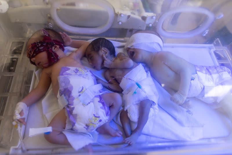 Three babies share an incubator at the premature infants ward at the Indira Gandhi hospital in Kabul