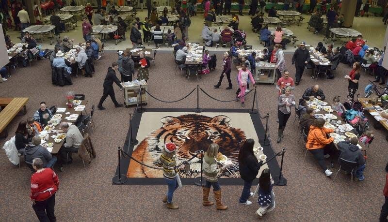 Attendees and volunteers make their way through the cafeteria at Beaver Falls High School during a free Christmas Day dinner in 2018 hosted by Christian Assembly's CARE Outreach Ministries.