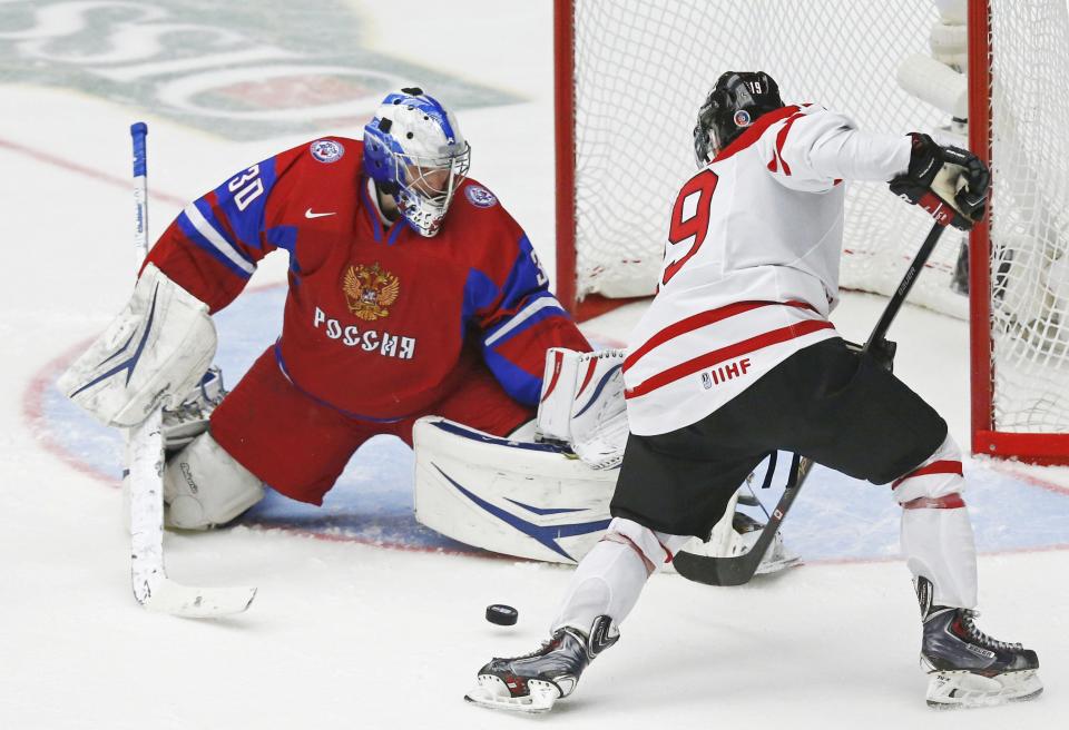 Russia's goalie Andrei Vasilevski makes a save on Canada's Nic Petan (R) during the third period of their IIHF World Junior Championship bronze medal ice hockey game in Malmo, Sweden, January 5, 2014. REUTERS/Alexander Demianchuk (SWEDEN - Tags: SPORT ICE HOCKEY)