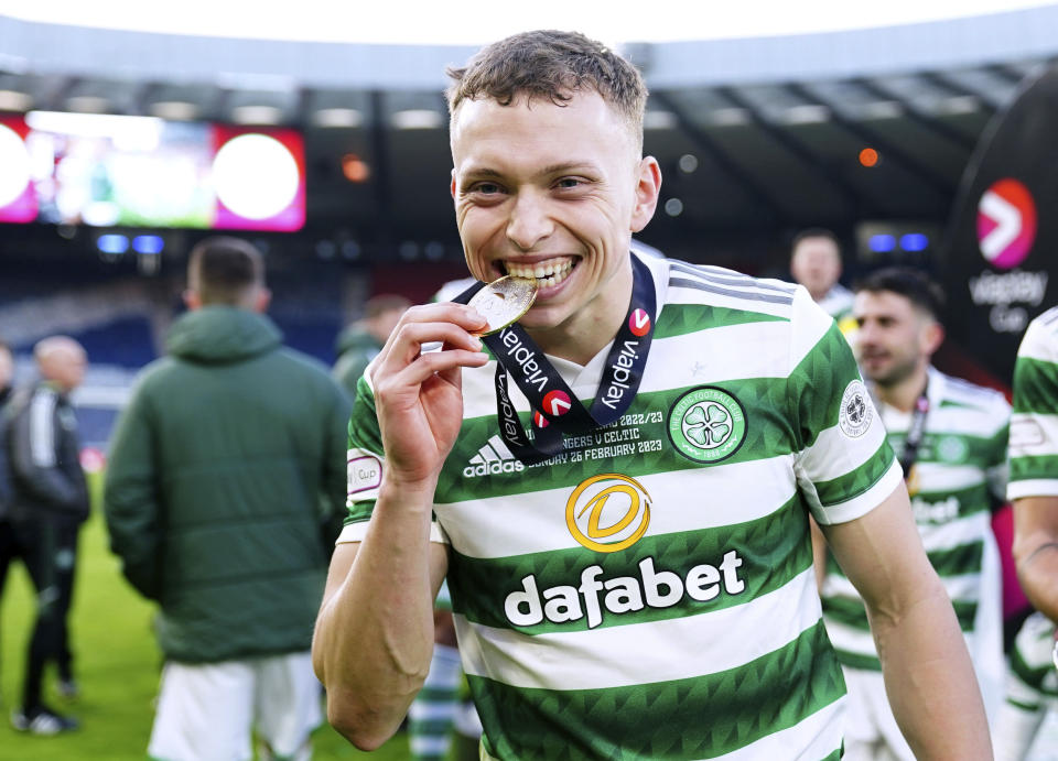Celtic's Alistair Johnston celebrates with his medal after winning the Scottish League Cup Final at Hampden Park, Glasgow, Scotland, Sunday Feb. 26, 2023. (Andrew Milligan/PA via AP)