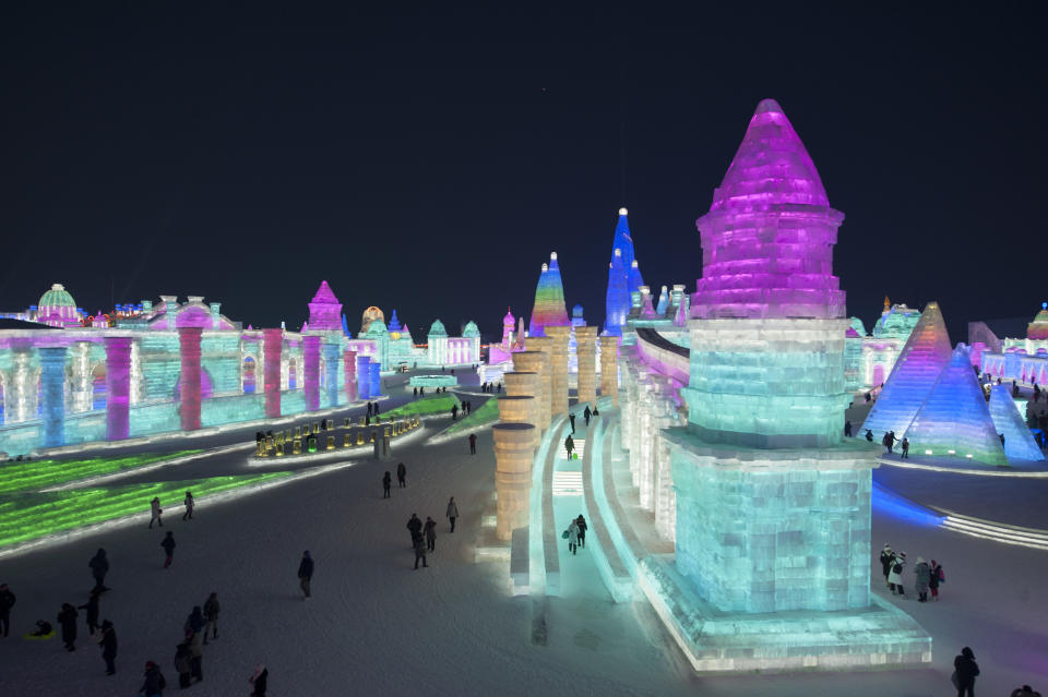 <p>Tourists visit illuminated ice sculptures at Ice and Snow World park on Jan. 4 in Harbin, China. (Photo: Tao Zhang/Getty Images) </p>