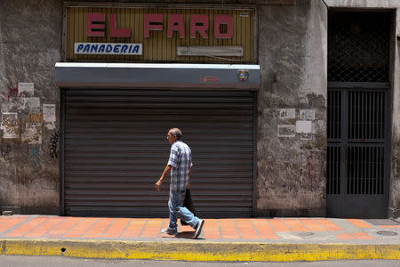 A man walks in front of a closed bakery in downtown Caracas, Venezuela August 18, 2018. REUTERS/Marco Bello