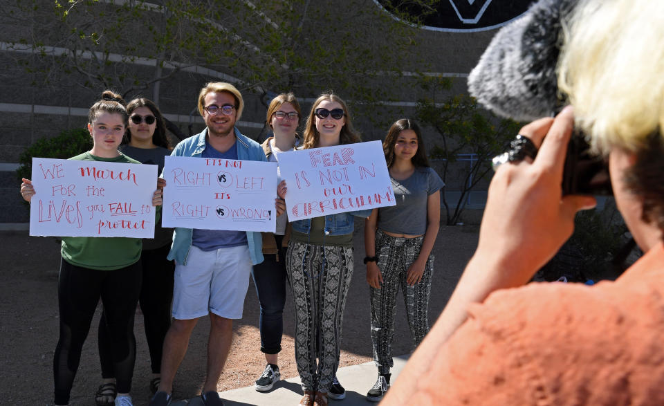 <p>Palo Verde High School students (L-R) Mallory McKissick, Raven Green, Eli Duncan, Nicole Sandberg, Ainslee Archibald and Sonia Agrebi pose outside the school while fellow student Jake Grosvenor takes photos as they participate in the National School Walkout on the 19th anniversary of the 1999 mass shooting that killed 13 people at Columbine High School on April 20, 2018 in Las Vegas, Nev. (Photo: Ethan Miller/Getty Images) </p>