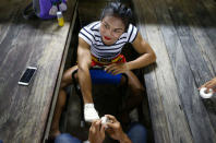 Muay Thai boxer Nong Rose Baan Charoensuk, 21, who is transgender, prepares for her boxing match at the Rajadamnern Stadium in Bangkok, Thailand, July 13, 2017. REUTERS/Athit Perawongmetha