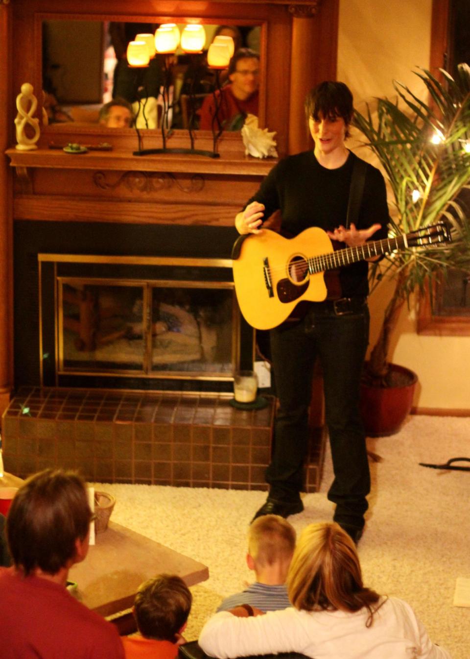 This Nov. 13, 2010 photo provided by Reggie Ruth Barrett shows singer-songwriter Ellis Delaney performing at a private residence The Pinery in Parker, Co. Enjoying live music at home is nothing new, whether it harks back to the humble notion of friends singing and playing instruments together at home, or to Europe's legendary salons full of writers, artists and musicians. House shows, or living-room shows, continue to bring satisfaction today to many music lovers and to amateur and professional musicians. (AP Photo/Reggie Ruth Barrett)