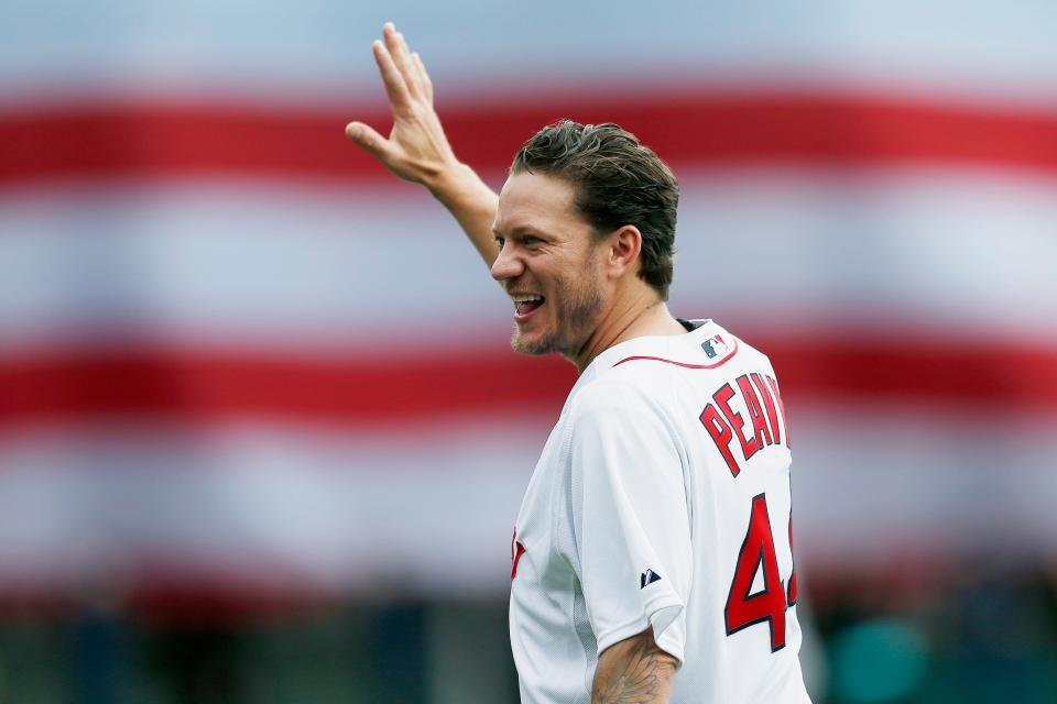 Former Boston Red Sox pitcher Jake Peavy walks to the mound for the ceremonial first pitch before a baseball game between the Red Sox and the Baltimore Orioles in Boston on April 15, 2019. Peavy, from Mobile, Alabama, has participated in Banana Ball games.