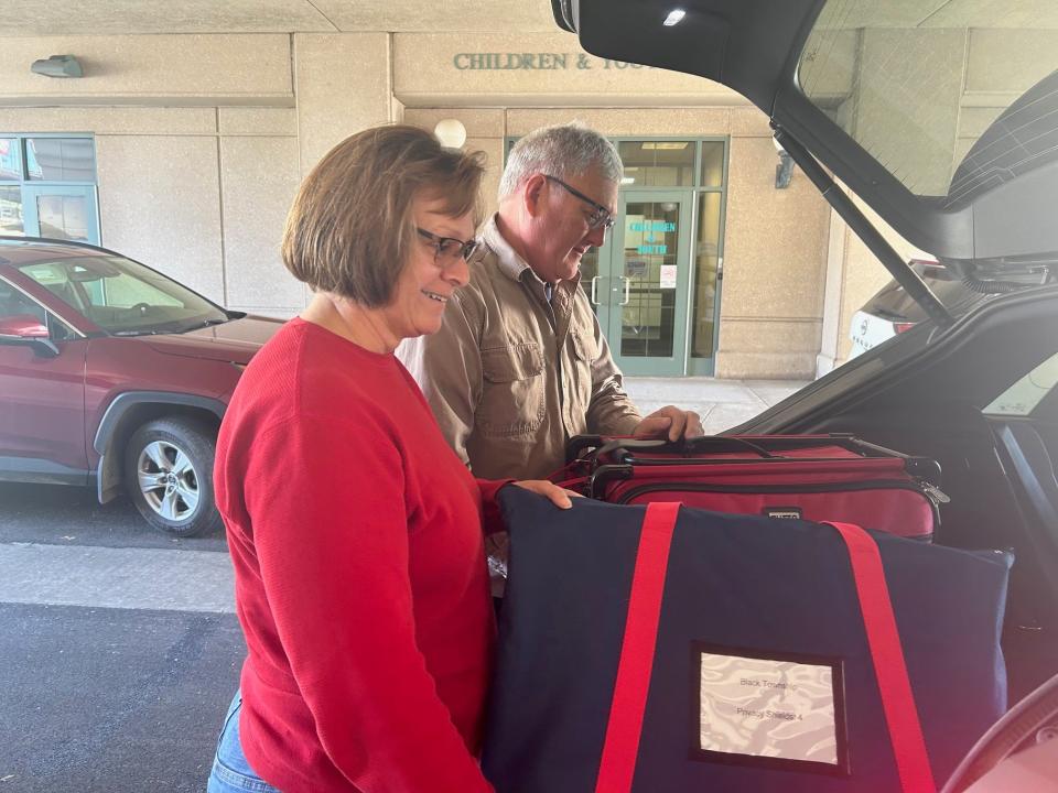 Cynthia Knopsnyder, front, and Oran Knopsnyder, back, pick up voting machines for Black Township on Monday in Somerset. Cynthia Knopsnyder said she is judge of elections for the township this year and Oran came along to help load the machines into the vehicle.