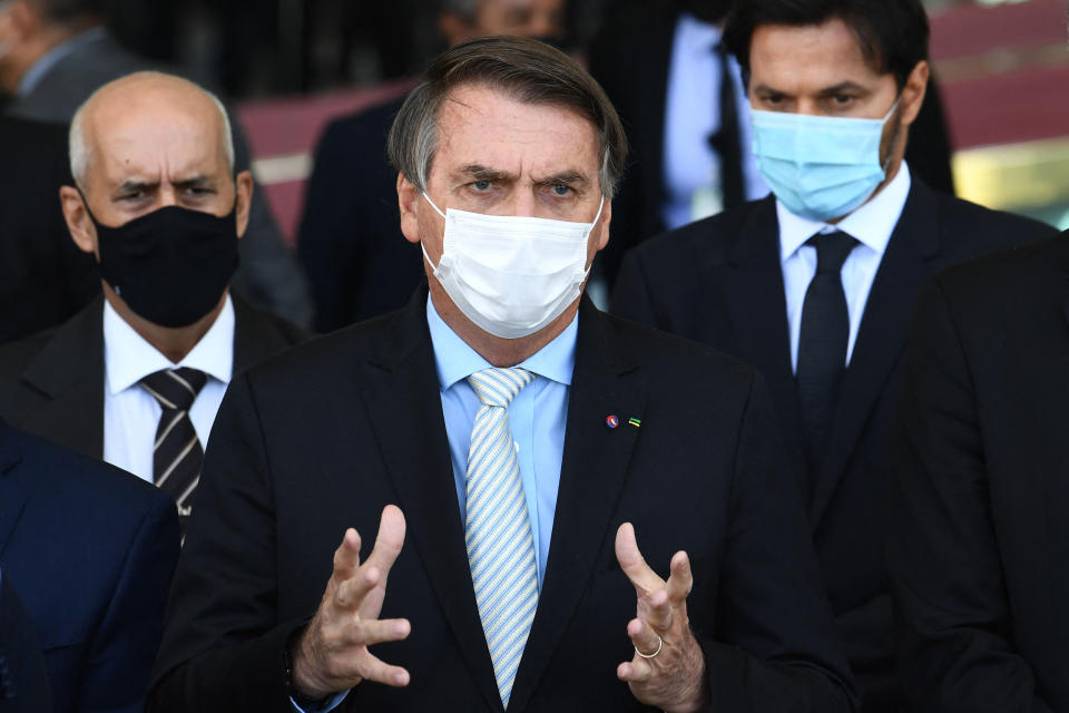 Brazilian President Jair Bolsonaro speaks to the press after meeting with the heads of the three government branches and their ministers to discuss possible solutions to the pandemic at the Alvorada Palace in Brasilia on March 24. (Photo: EVARISTO SA via Getty Images)