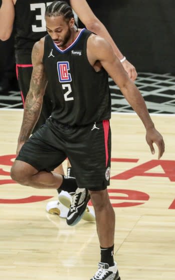 Clippers forward Kawhi Leonard stretches his right knee during Game 4 against the Jazz.