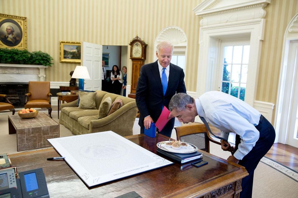 Obama blows out candles after Biden surprised him with some birthday cupcakes on Aug. 4.