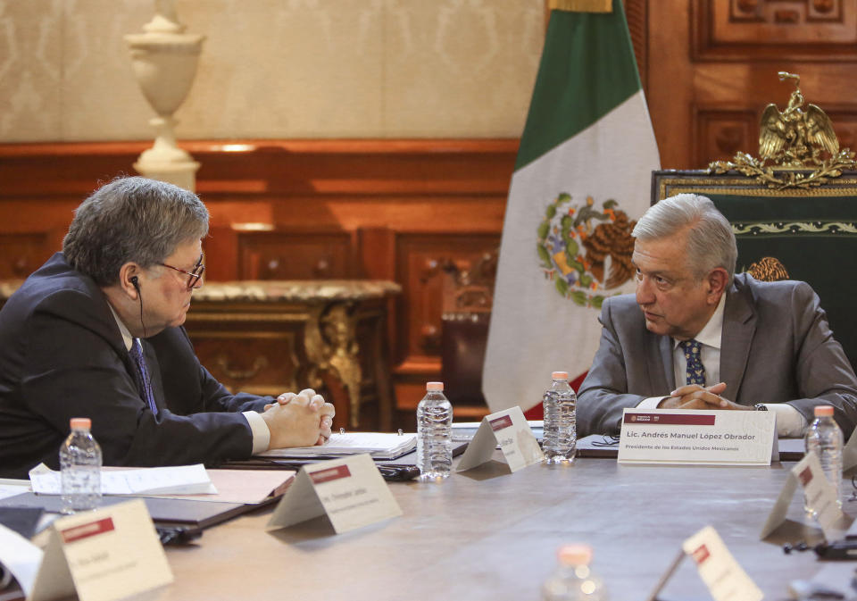 In this photo provided by the Mexican presidential press office, U.S. Attorney General William Barr, left, speaks with Mexican President Andres Manuel Lopez Obrador at the National Palace in Mexico City, Thursday, Dec. 5, 2019. The closed-door meeting came about a week after U.S. President Donald Trump suggested his government could classify Mexican cartels as terrorist organizations. (Mexican presidential press office via AP)