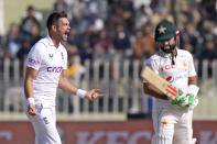 England's James Anderson, left, celebrates after taking the wicket of Muhammad Rizwan, right, during the fifth day of the first test cricket match between Pakistan and England, in Rawalpindi, Pakistan, Monday, Dec. 5, 2022. (AP Photo/Anjum Naveed)