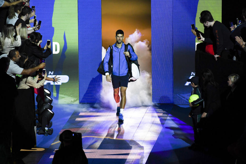 Novak Djokovic of Serbia enters the court prior to his match against Roger Federer of Switzerland during their ATP World Tour Finals singles tennis match at the O2 Arena in London, Thursday, Nov. 14, 2019. (AP Photo/Alberto Pezzali)