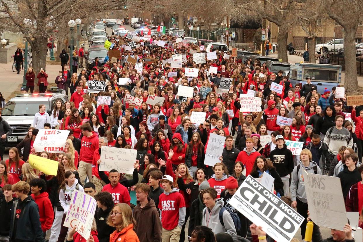 a large group of people holding signs