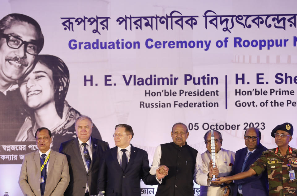 Bangladesh Science and Technology Minister Yafesh Osman celebrates after receiving a model of the fuel assembly from ROSATOM Director-General Alexey Likhachev during the fuel handover ceremony of the Rooppur Nuclear Power Plant at Ishwardi in Pabna, Bangladesh, Thursday, Oct.5, 2023. (AP Photo/Mahmud Hossain Opu)