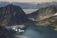 FILE - In this Aug. 14, 2019, file photo, icebergs are photographed from the window of an airplane carrying NASA scientists as they fly on a mission to track melting ice in eastern Greenland. As warmer temperatures cause the ice to retreat the Arctic region is taking on new geopolitical and economic importance, and not just the United States hopes to stake a claim, with Russia, China and others all wanting in. (AP Photo/Mstyslav Chernov, File)