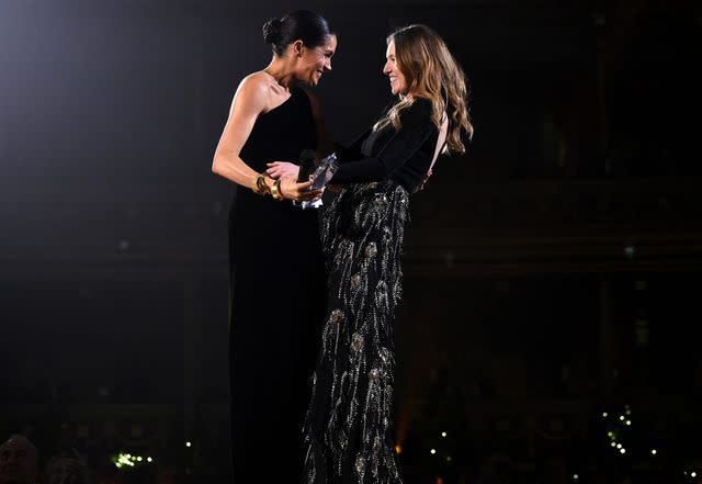 <p>Joe Maher/BFC/Getty</p> Claire Waight Keller and Meghan Markle at the British Fashion Awards in December 2018