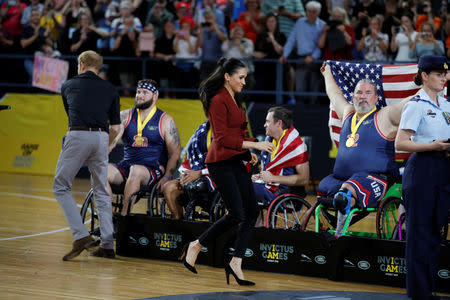 Britain's Prince Harry and Meghan, Duchess of Sussex, hand awards to the Invictus Games Sydney 2018 wheelchair basketball medallists at Quaycentre in Sydney, Australia October 27, 2018. REUTERS/Phil Noble