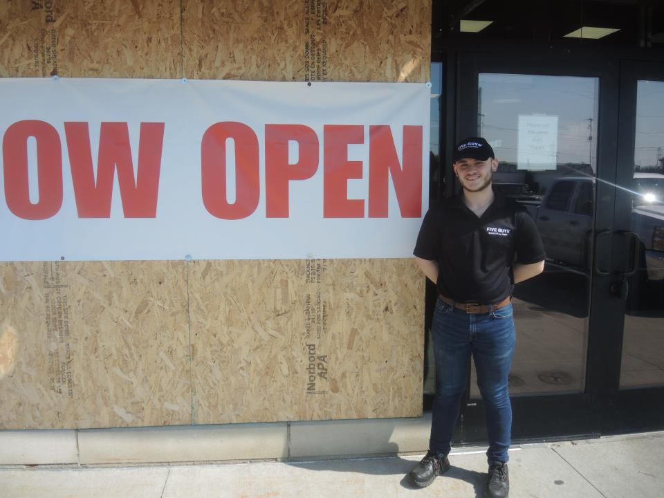 Tim Short is the manager for the Five Guys restaurant which reopened on July 1. He said customers have been understanding about the plywood on the store's exterior.