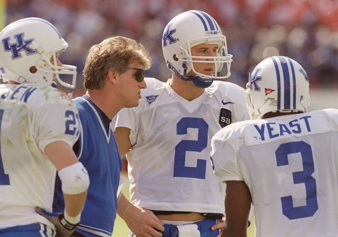 Kentucky head coach Hal Mumme talked with quarter back Tim Couch (2) and wide receivers Lance Mickelsen (21) and Craig Yeast (3) during the Outback Bowl against Penn State in Tampa, Fla., on Jan. 1, 1999.