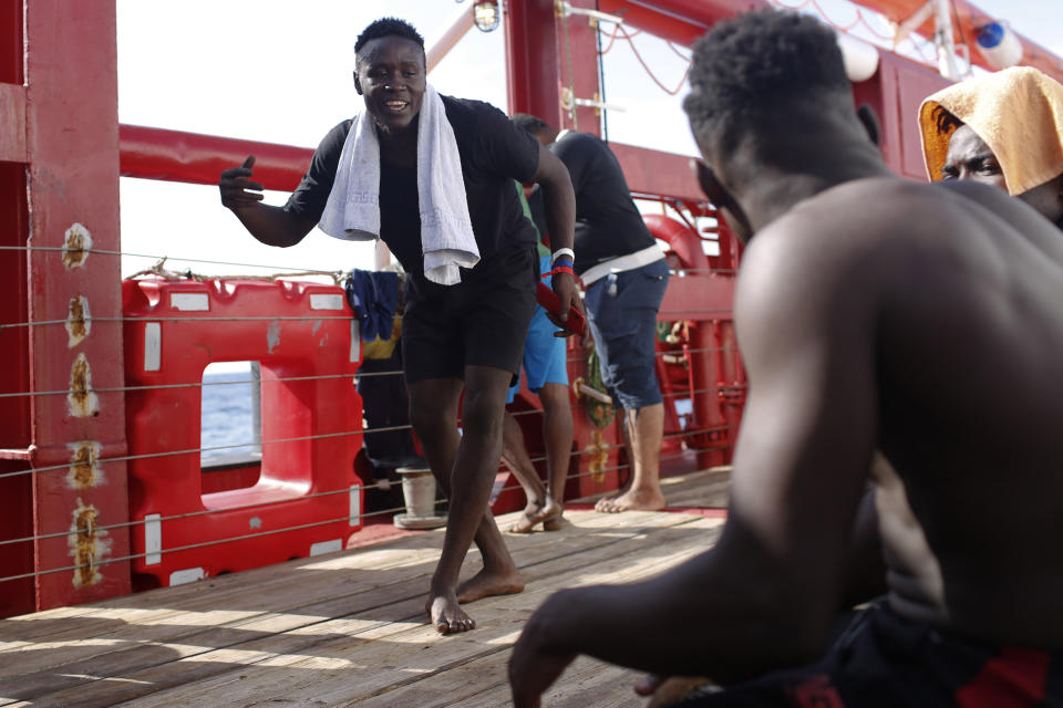 Un hombre baila mientras otro toca un tambor a bordo del Ocean Viking, un barco que rescata migrantes africanos en el Mediterráneo. Foto del 12 de septiembre del 2019. (AP Photo/Renata Brito)