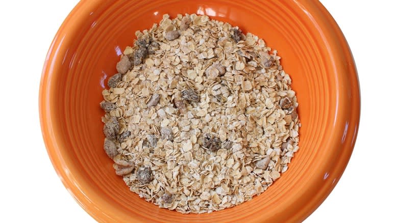 Uncooked instant oatmeal in orange ceramic bowl