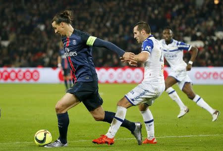 Football Soccer - Paris St Germain vs Bastia - French Ligue 1 - Parc des Princes, Paris, France - 8/1/16. Paris St Germain's Zlatan Ibrahimovic in action with Bastia's Florian Marange REUTERS/Gonzalo Fuentes