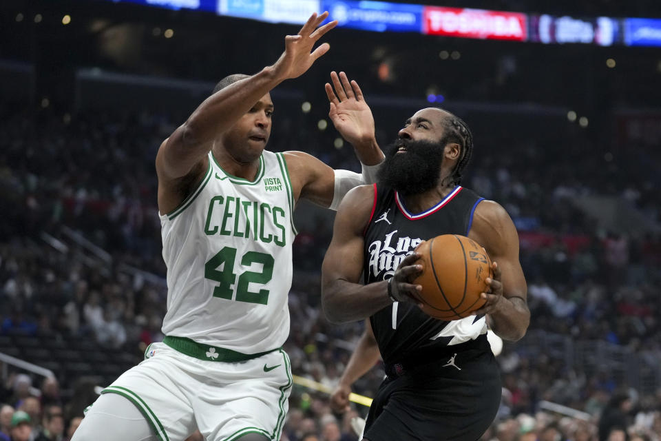 Los Angeles Clippers guard James Harden (1) drives against Boston Celtics center Al Horford (42) during the first half of an NBA basketball game in Los Angeles, Saturday, Dec. 23, 2023. (AP Photo/Eric Thayer)