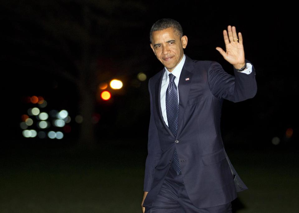 President Barack Obama waves as he arrives on the South Lawn of the White House after returning from Korea on Tuesday, March 27, 2012, in Washington. (AP Photo/Evan Vucci)