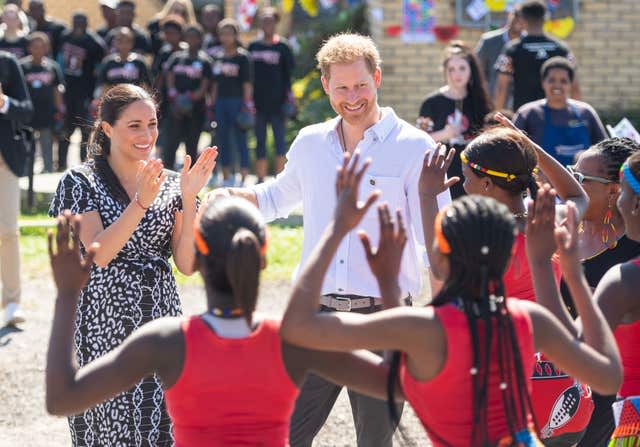 Meghan, pictured with Harry in the Nyanga Township in Cape Town, launched her legal action while in South Africa. Dominic Lipinski/PA Wire