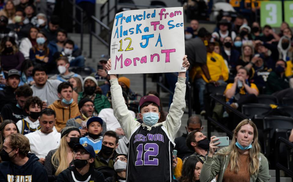 A fan holds up a sign for Memphis Grizzlies guard Ja Morant during the second half of the Grizzlies' NBA basketball game against the Denver Nuggets on Friday, Jan. 21, 2022, in Denver. The Grizzlies won 122-118. (AP Photo/David Zalubowski)