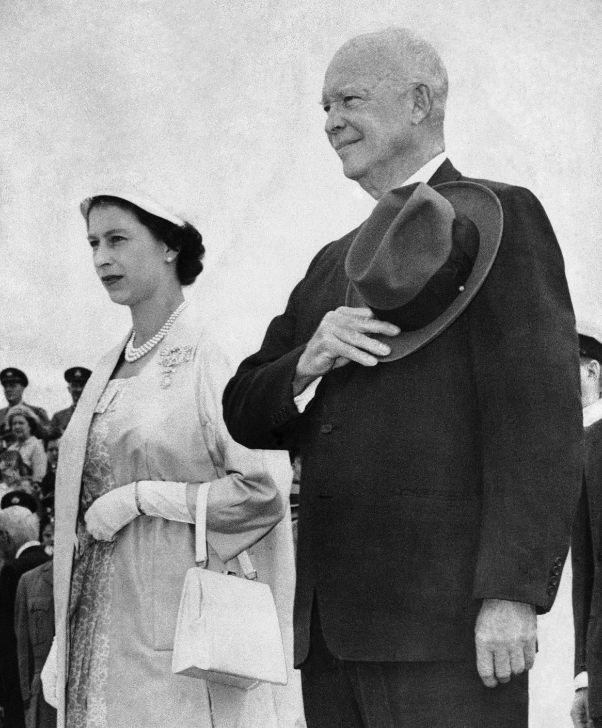 Queen Elizabeth II and President Dwight D. Eisenhower (34th president) stand at Dais as their national anthems are played at St. Hubert RCAF station after their meeting for the official opening of the St. Lawrence Seaway on June 26, 1959.