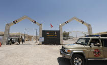 POOL - Iraqi security forces stand guard at the Iraq-Iran border crossing of Mandali in northern province of Diyala, Iraq, Saturday, July, 11, 2020. Al-Kadhimi launched a campaign in the northern province of Diyala to enforce the proper payment of taxes on imported goods and recover "hundreds of millions of dollars" in revenues lost to bribery and other illicit practices. Security forces from the Interior Ministry would supervise the work of border guards in the first step of the campaign in the Mandili border crossing, he told reporters. (Thaier al-Sudani/Pool Photo via AP)