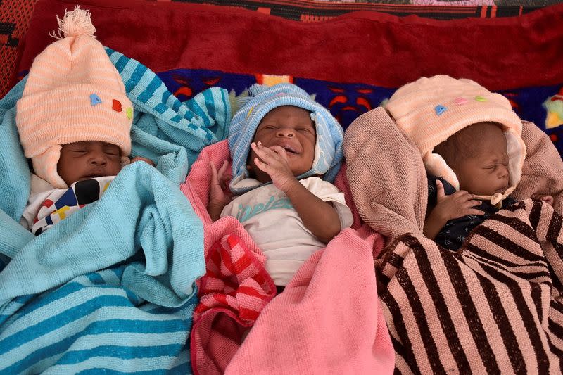 Triplets who were born to Fatime Eliane, a Cameroonian woman, lie inside a tent at the refugee camp on the outskirts of N'djamena